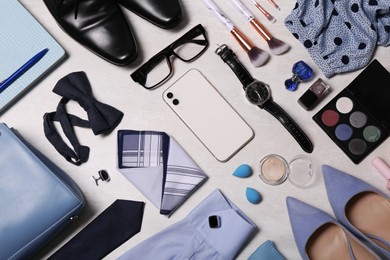 Flat lay composition with fashionable woman's and man's accessories on light background