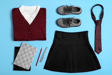 Flat lay composition with school uniform on blue background