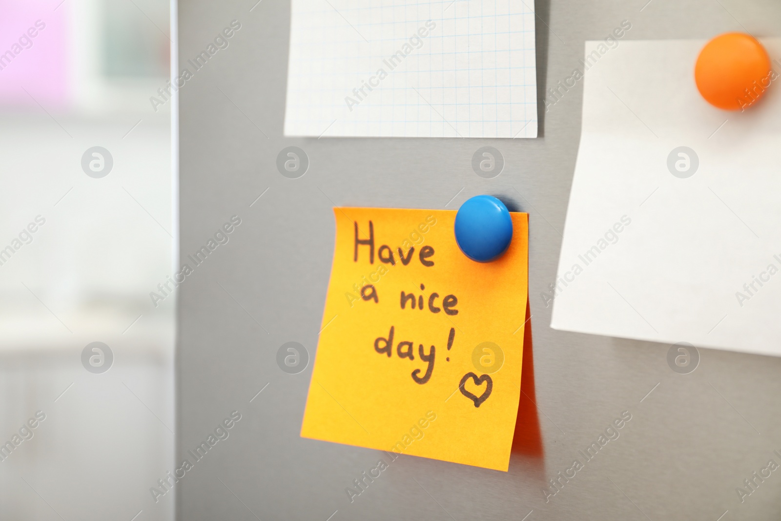 Photo of Note with text "Have a nice day" and empty sheets on refrigerator door in kitchen. Space for text