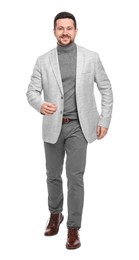 Photo of Handsome bearded businessman walking on white background