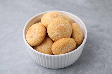 Photo of Tasty sugar cookies in bowl on grey table