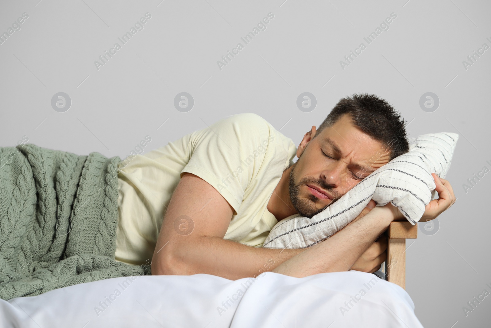 Photo of Tired man sleeping in bed at home