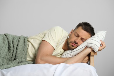 Photo of Tired man sleeping in bed at home