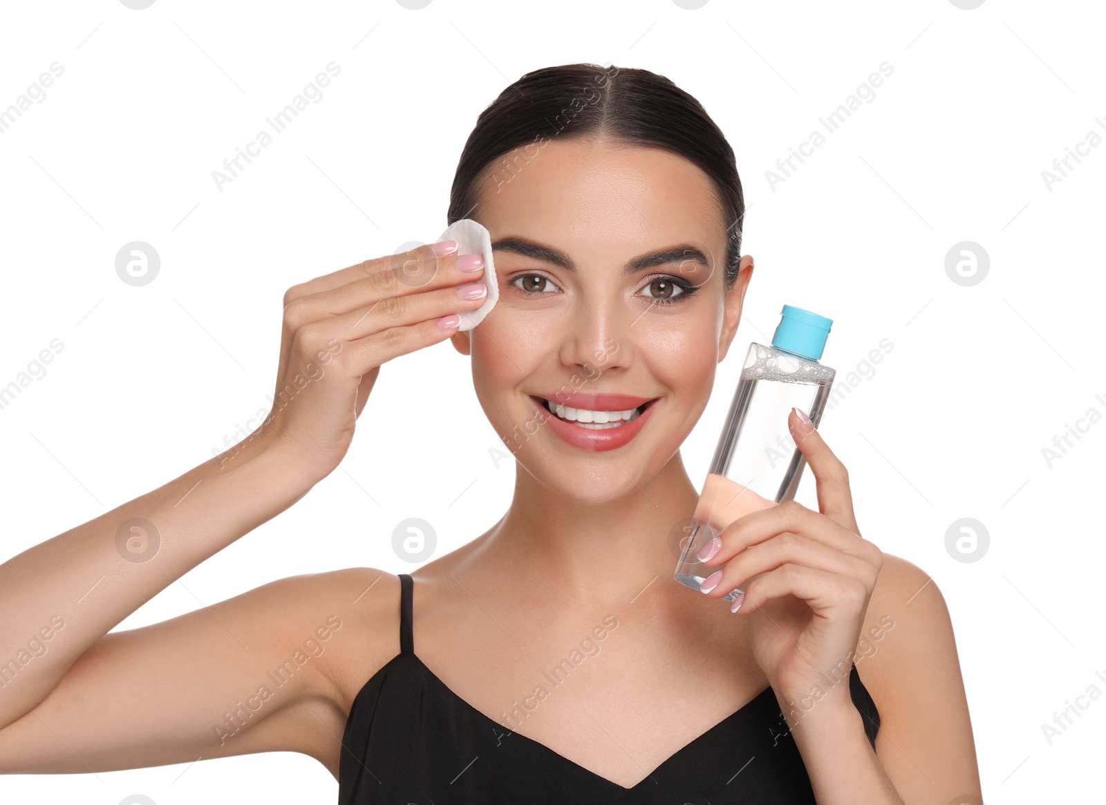 Photo of Beautiful woman removing makeup with cotton pad on white background