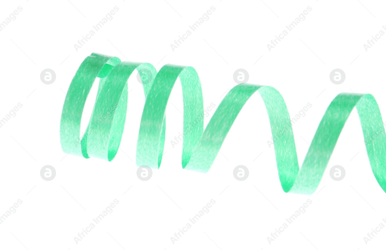 Photo of Green serpentine streamer on white background. Festive decor