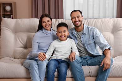 Happy international family on sofa at home