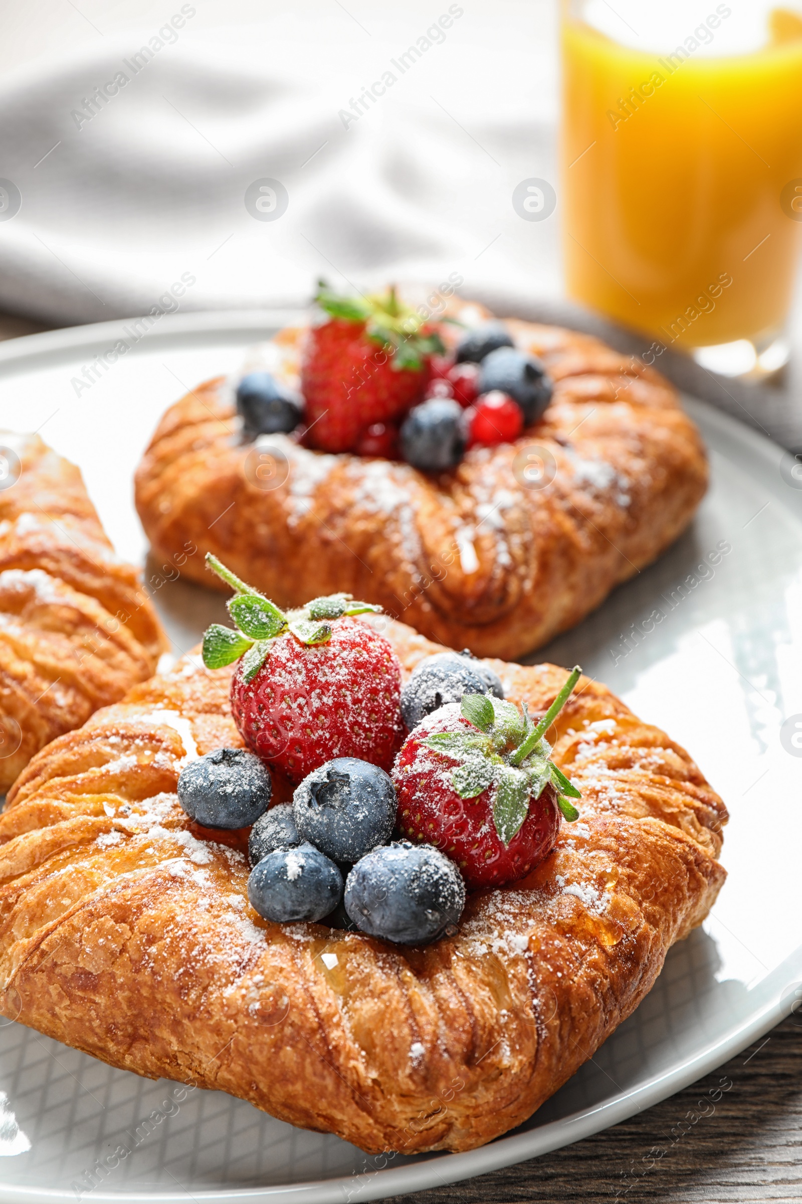 Photo of Fresh delicious puff pastry with sweet berries on table, closeup