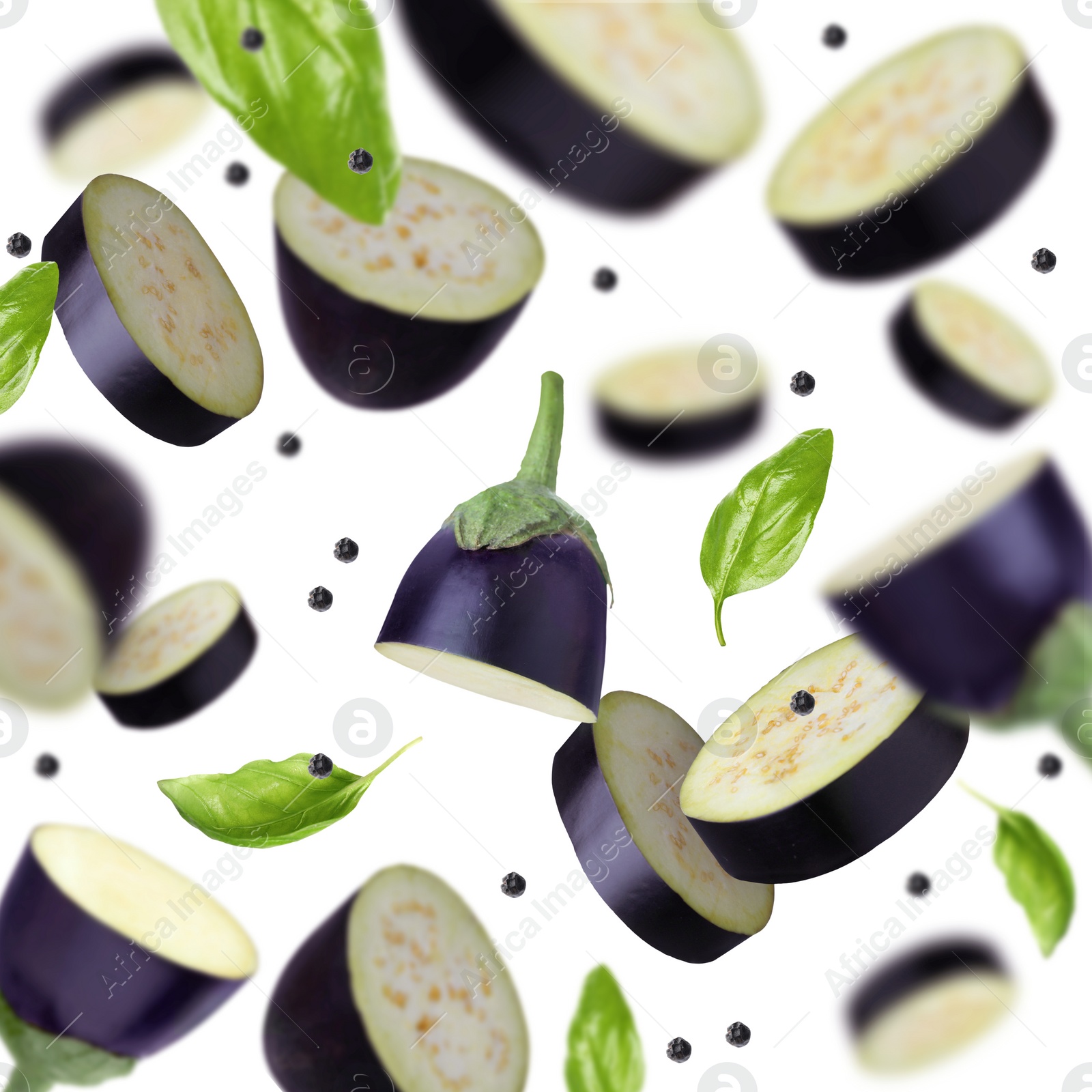 Image of Cut eggplants, basil and peppercorns falling on white background