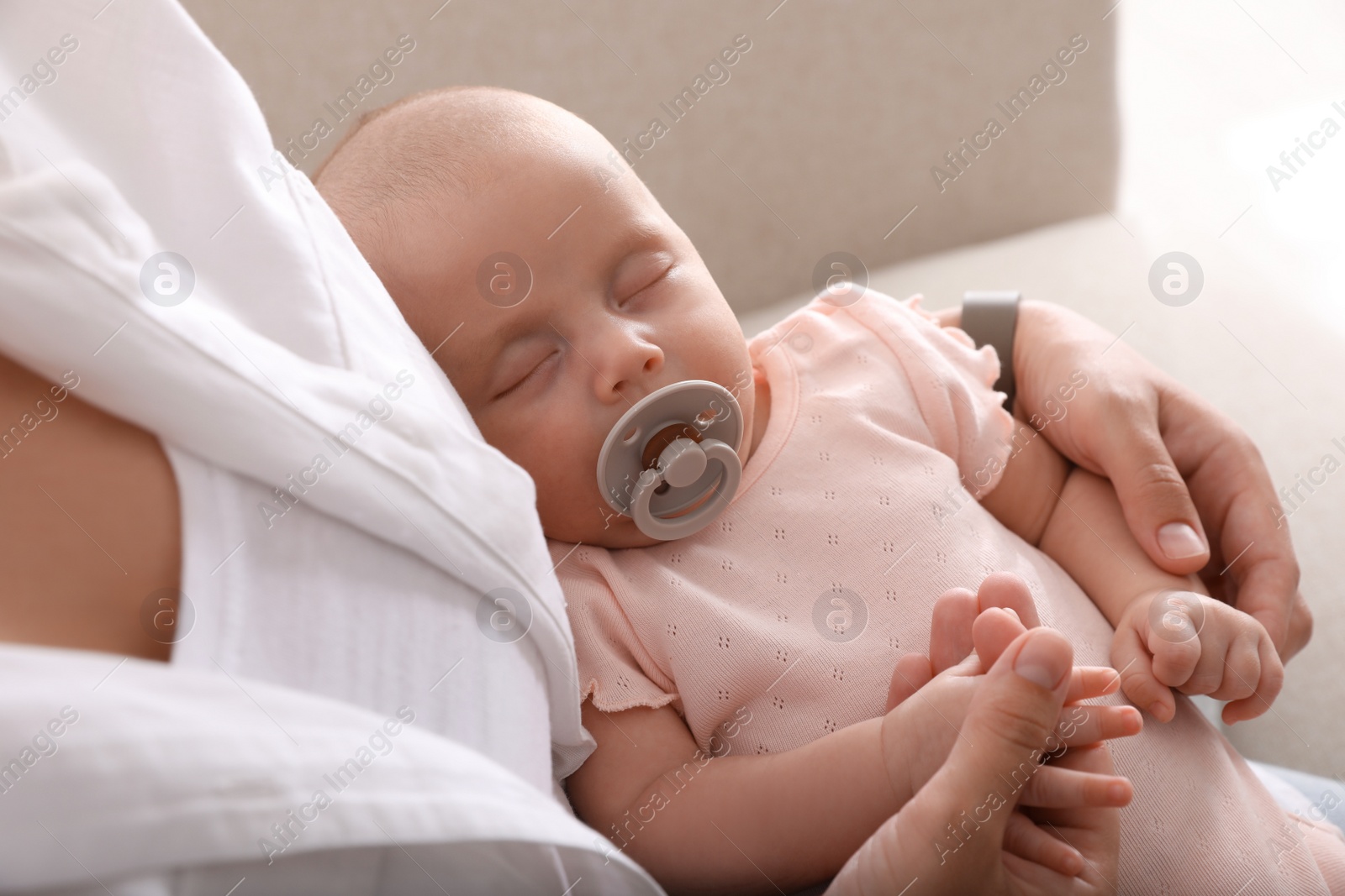 Photo of Mother with her cute sleeping baby at home, above view