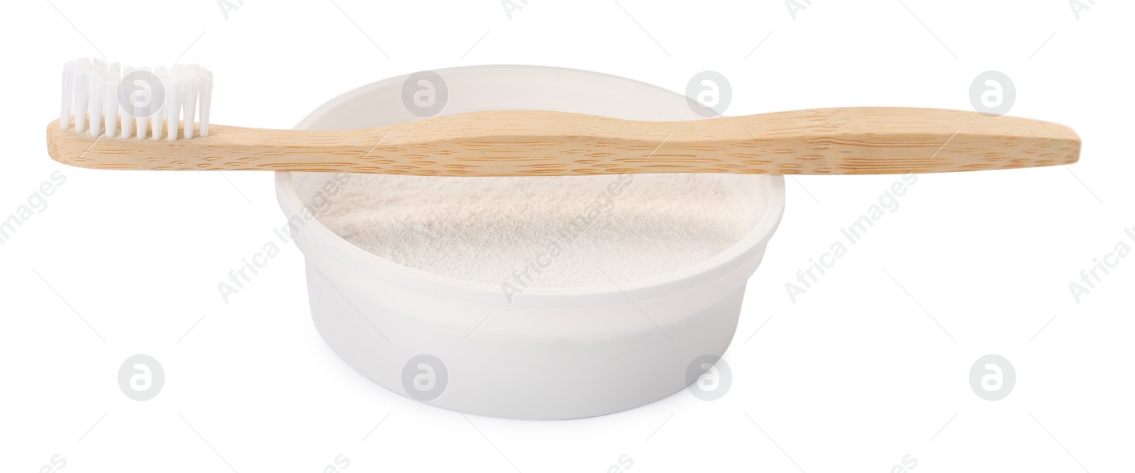 Photo of Bowl of tooth powder and brush on white background