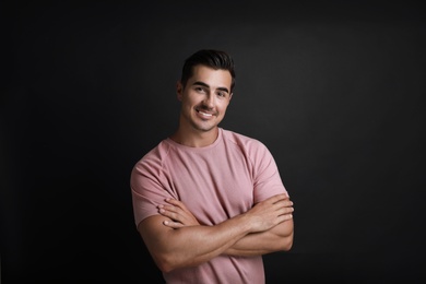 Photo of Portrait of handsome young man on black background