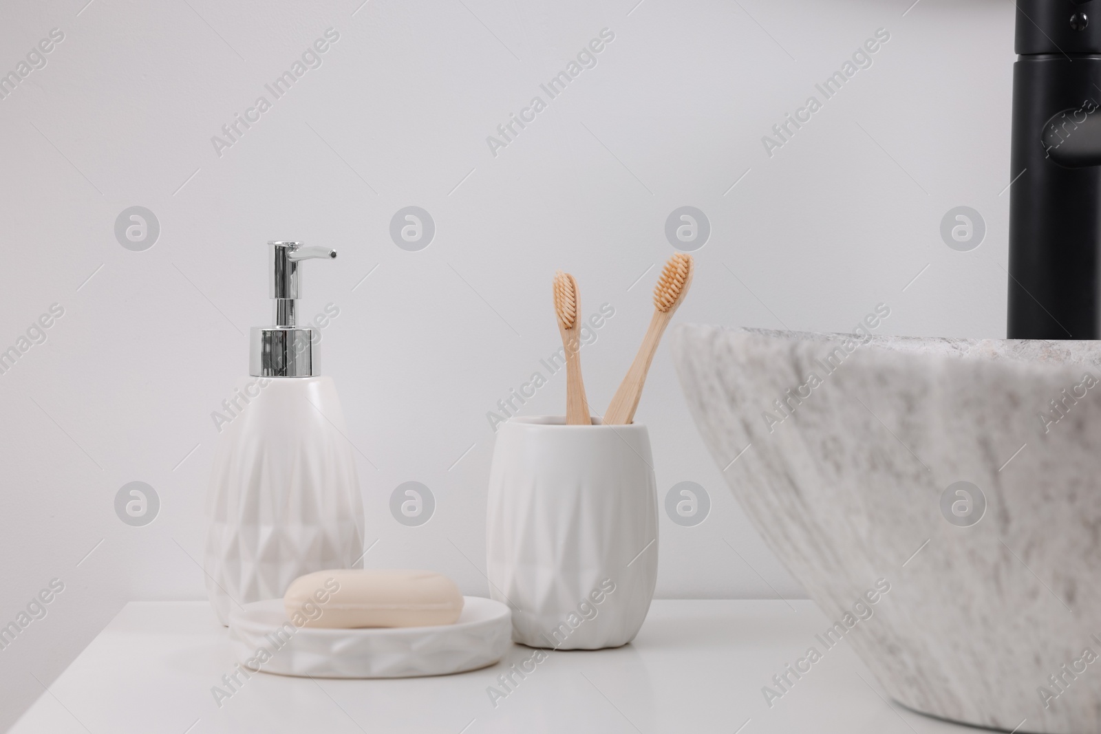 Photo of Different bath accessories and personal care products on white countertop in bathroom