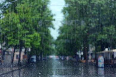 Photo of Blurred view of city street on rainy day