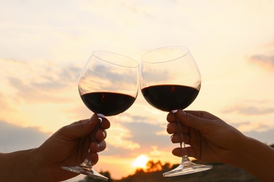 Photo of Romantic couple drinking wine together on beach, closeup view