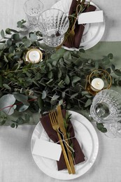 Photo of Luxury table setting with beautiful decor and blank cards. Festive dinner