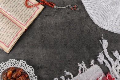 Photo of Flat lay composition with Muslim prayer beads, Quran and space for text on grey background