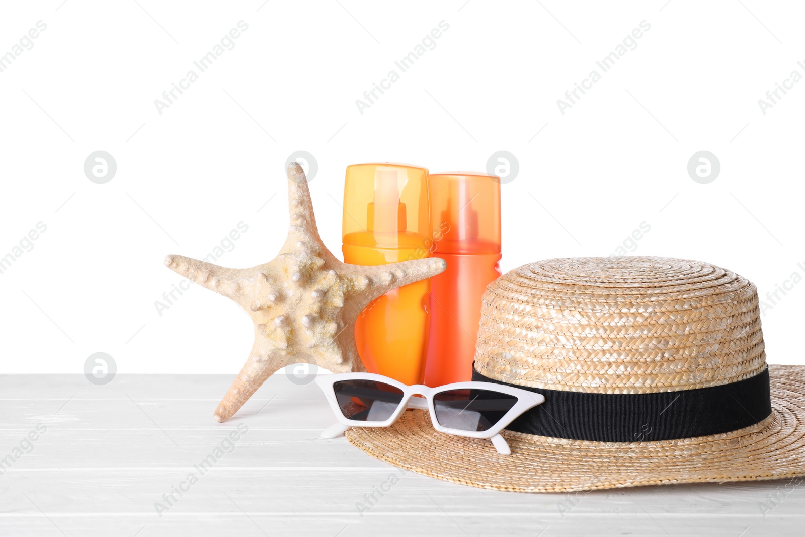 Photo of Composition with sun protection products on wooden table against white background