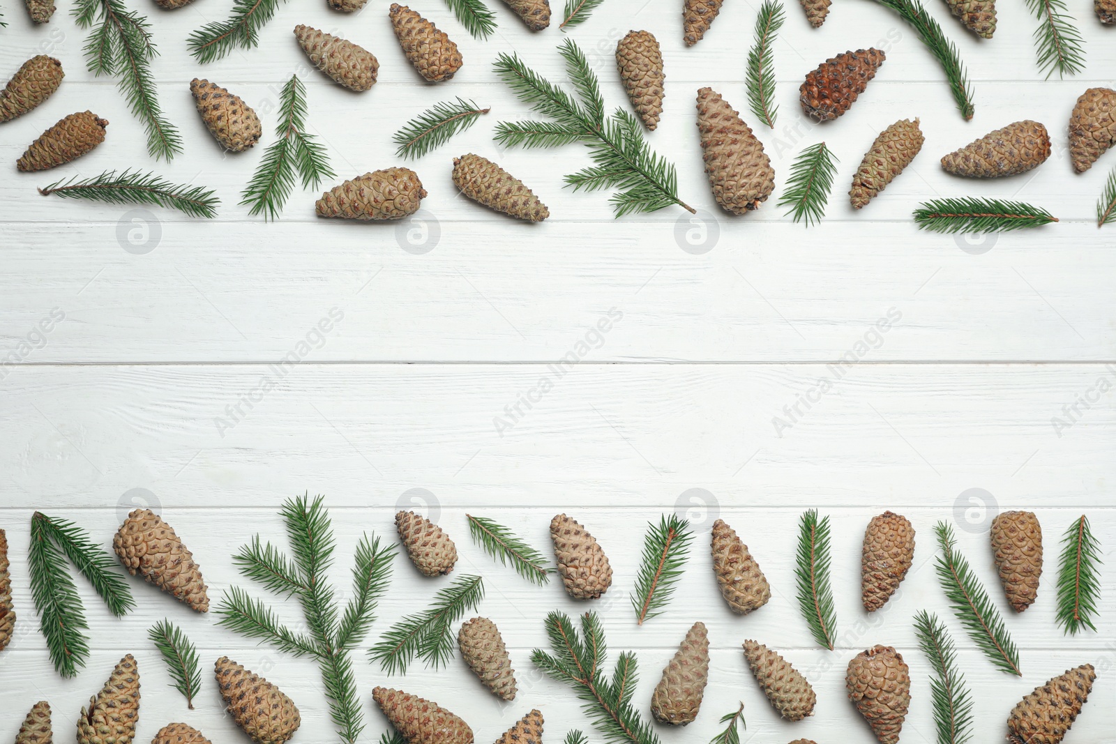 Photo of Flat lay composition with pinecones on white wooden background, space for text