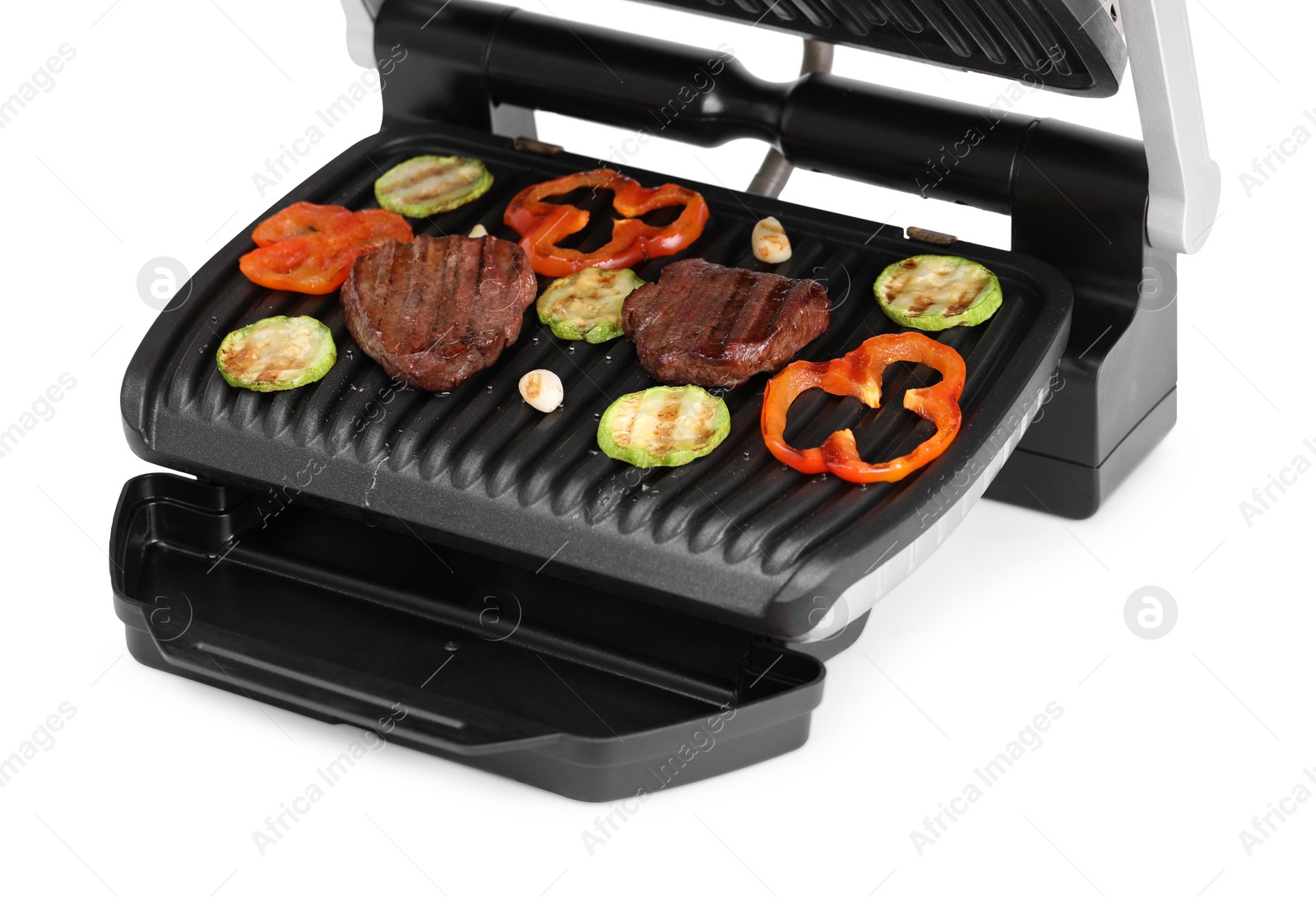 Photo of Electric grill with tasty meat and vegetables isolated on white