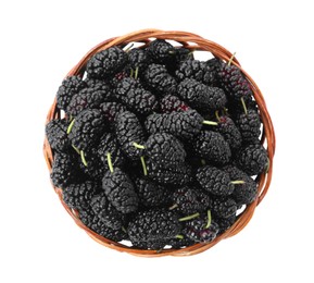 Photo of Ripe black mulberries in wicker bowl on white background, top view