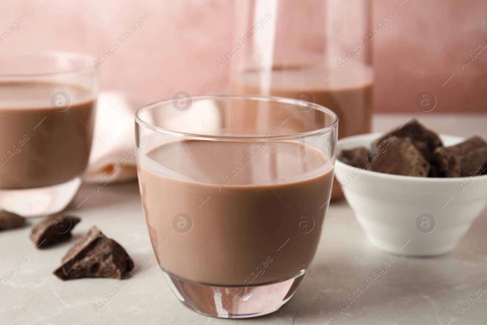 Photo of Glass with tasty chocolate milk on table. Dairy drink