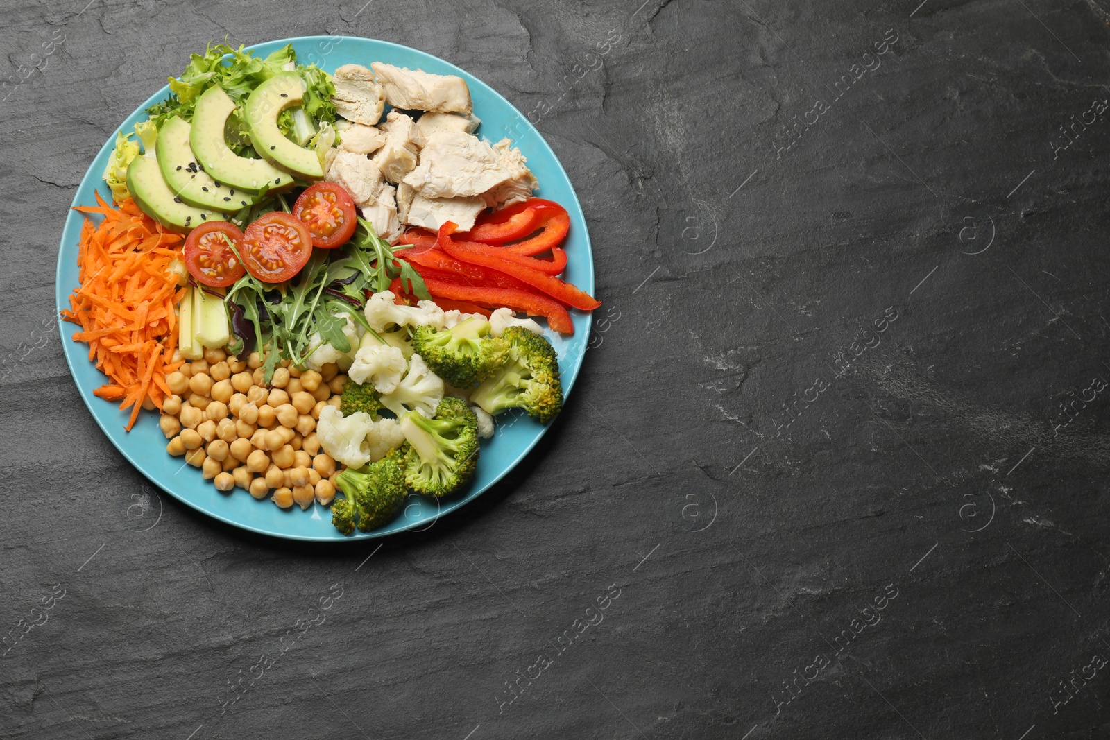 Photo of Balanced diet and healthy foods. Plate with different delicious products on black table, top view. Space for text