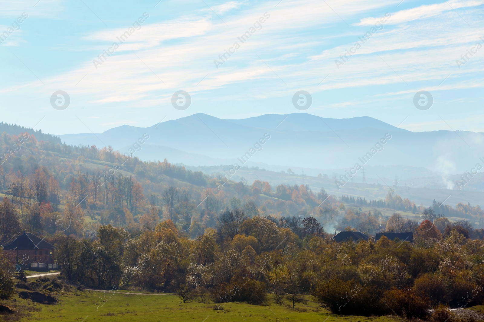 Photo of Beautiful landscape with houses and foggy mountain slopes