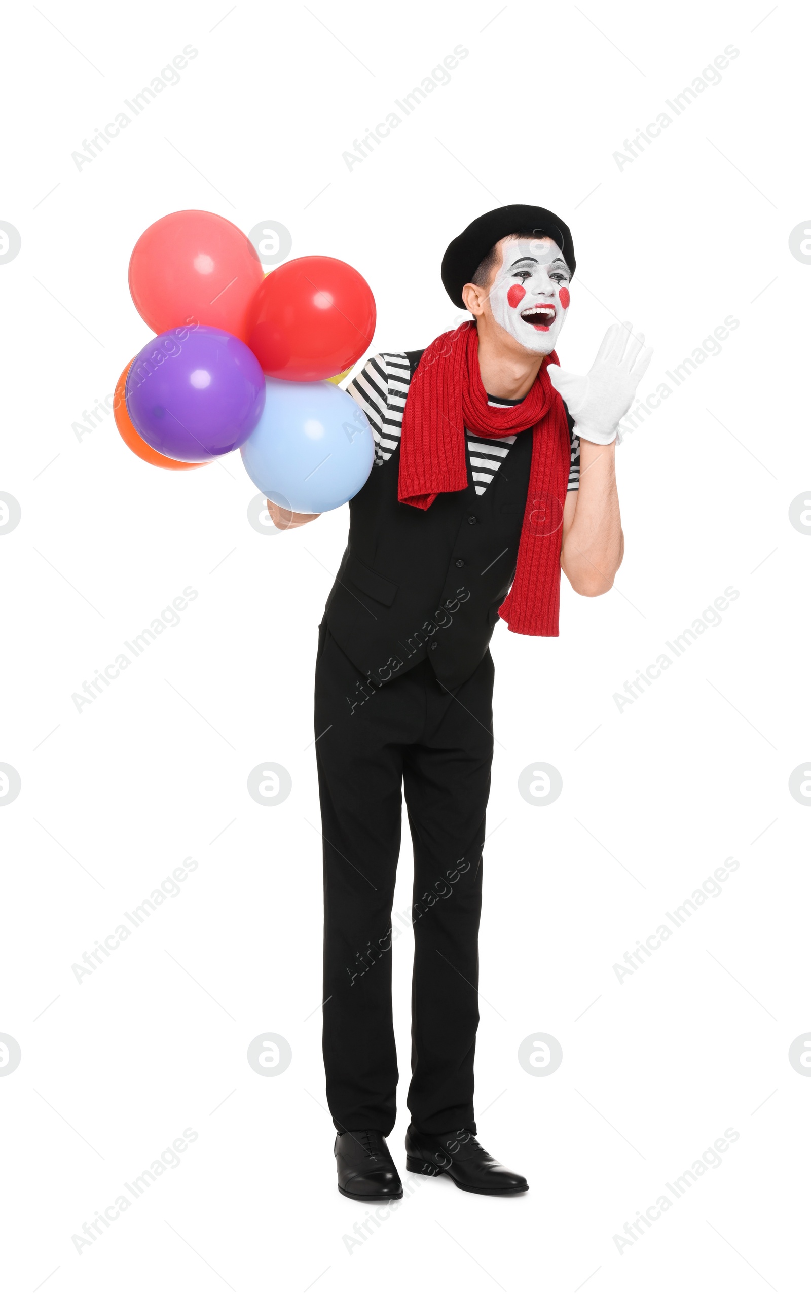 Photo of Funny mime artist with balloons screaming on white background