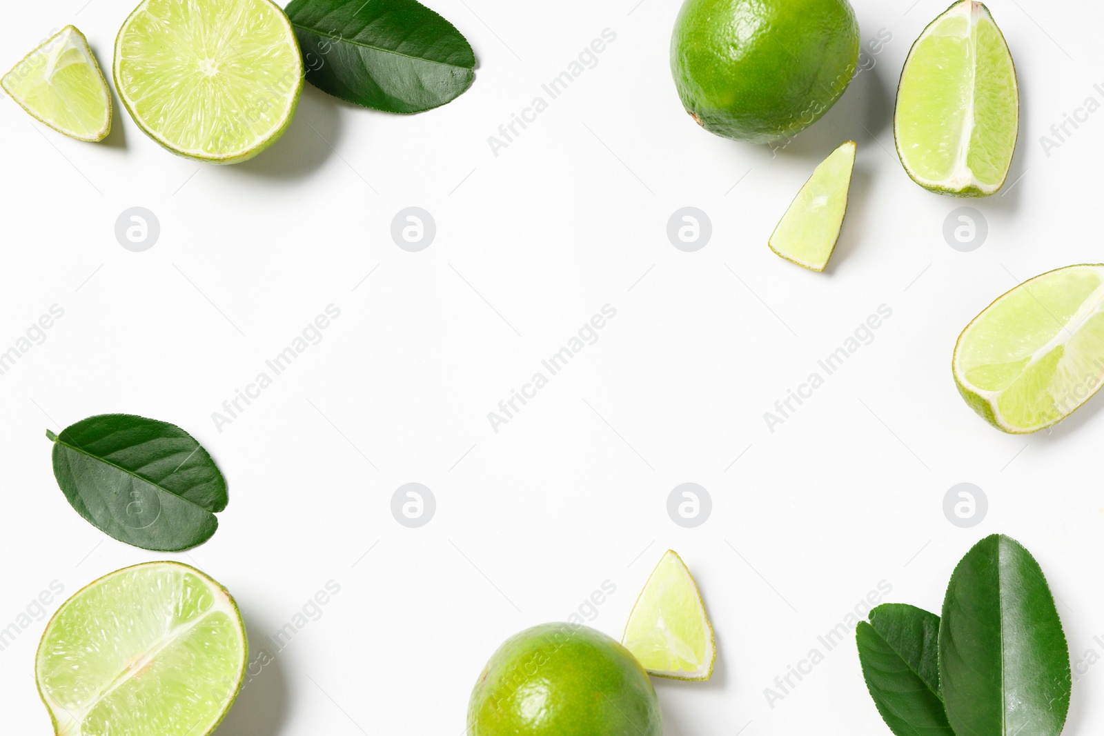 Photo of Fresh ripe limes and leaves on white background, flat lay. Space for text