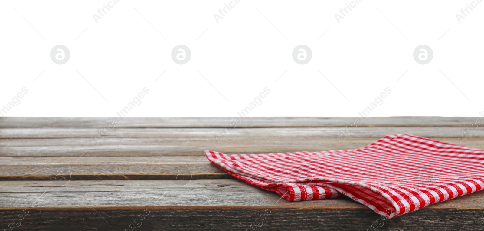 Photo of Red checkered napkins on wooden table against white background. Mockup for design