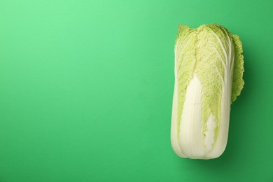 Photo of Fresh ripe Chinese cabbage on green background, top view. Space for text