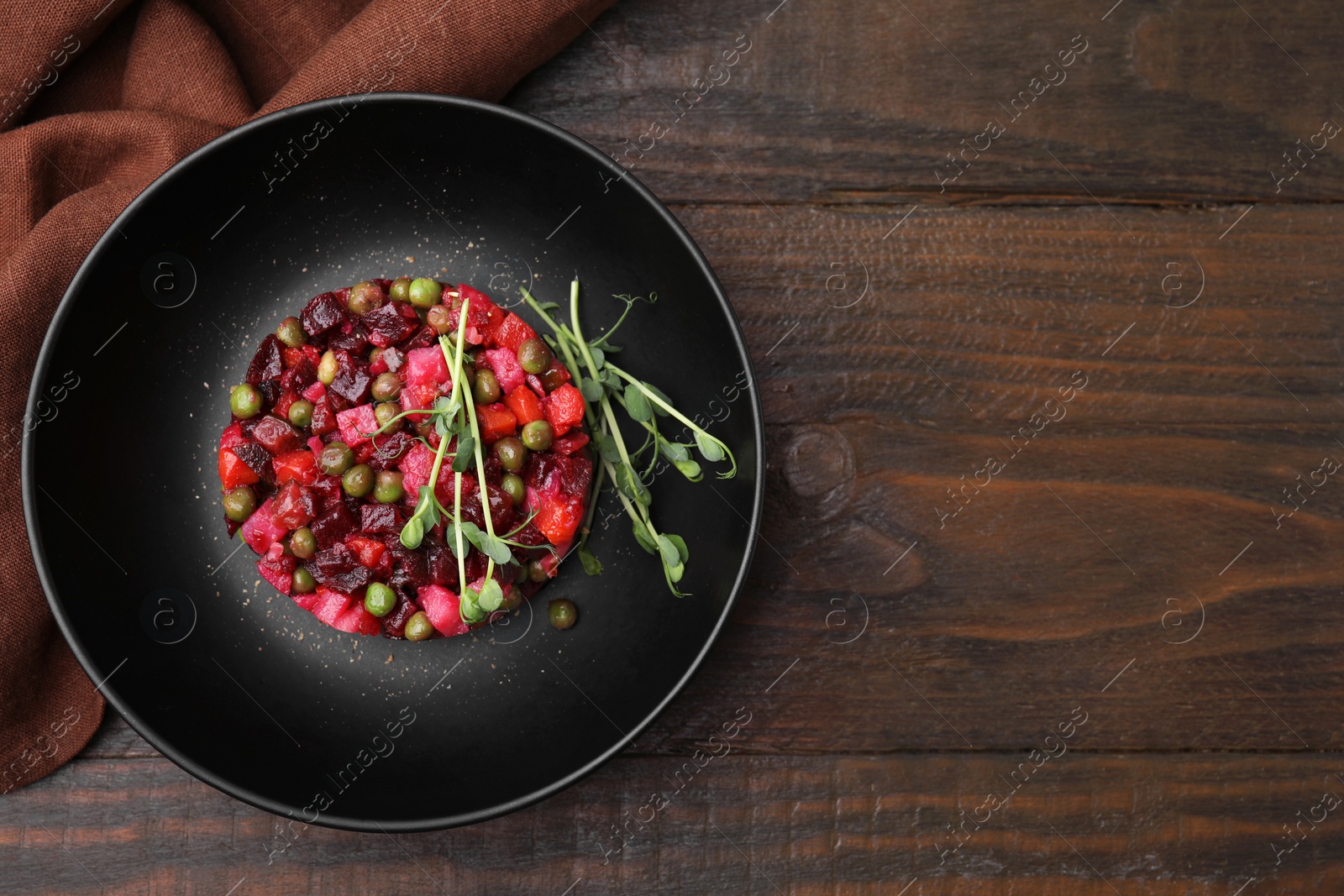 Photo of Delicious vinaigrette salad on wooden table, flat lay. Space for text