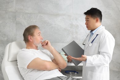 Photo of Senior patient having appointment with doctor in clinic