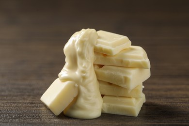 Photo of Pieces of white chocolate and tasty paste on wooden table, closeup