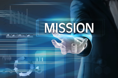 Image of Mission concept. Businessman demonstrating word and charts on background