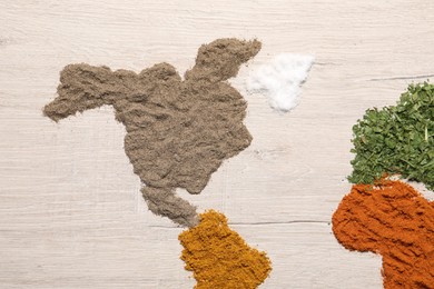Photo of Continents of different spices on wooden table, flat lay