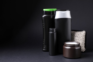Set of different men's cosmetic products on black background. Space for text