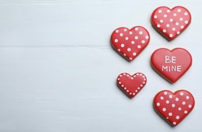 Delicious heart shaped cookies on white wooden table, flat lay with space for text. Valentine's Day