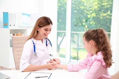 Photo of Doctor checking little girl's pulse in hospital