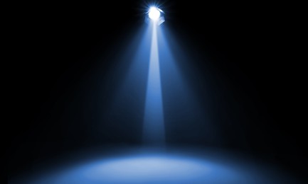 Image of Bright spotlight in darkness. Professional stage equipment