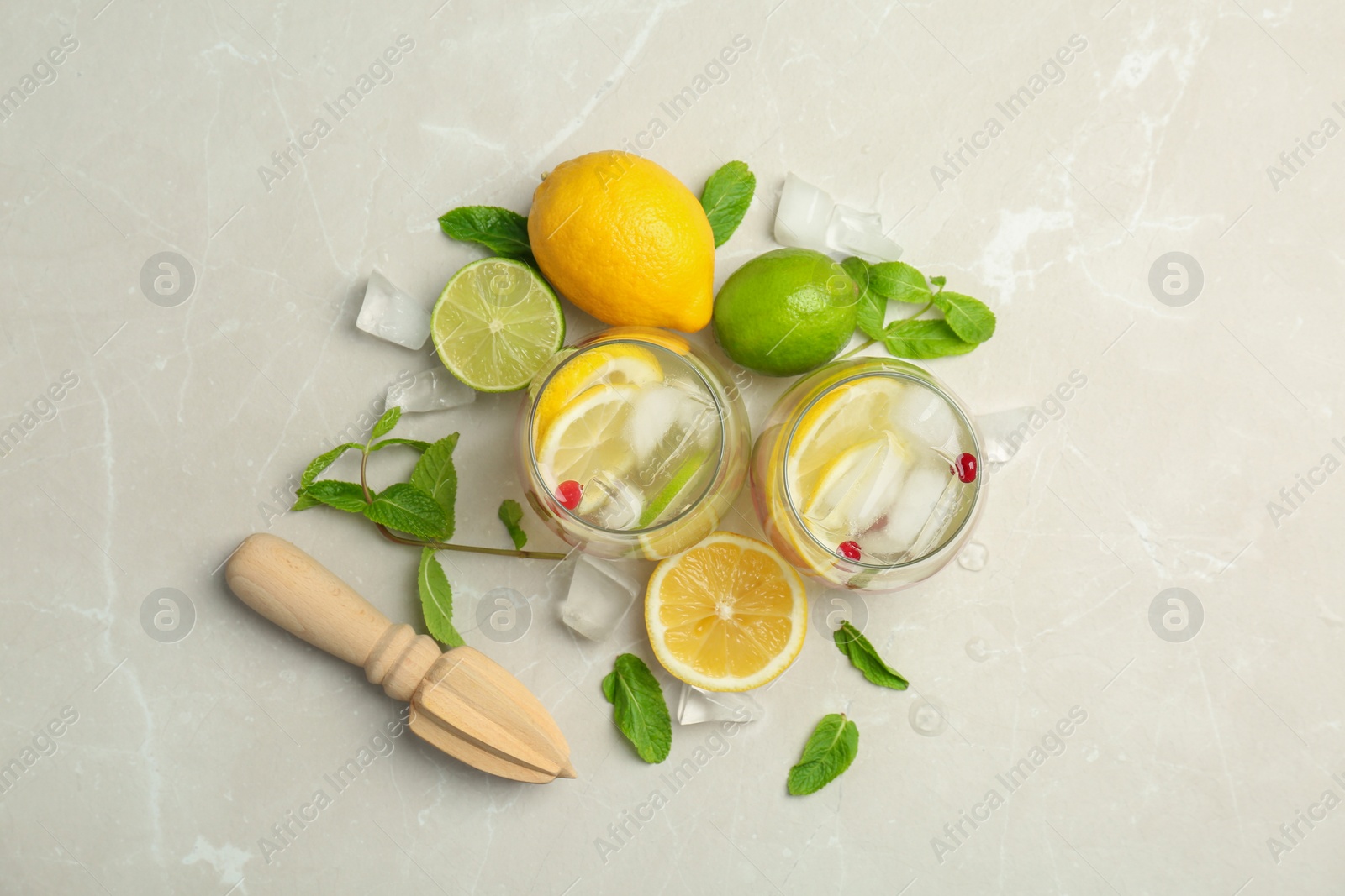 Photo of Flat lay composition with delicious natural lemonade on light background