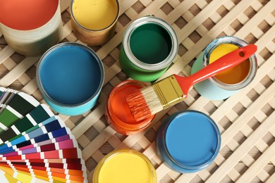 Photo of Different paints with brush and palette on wooden background, above view