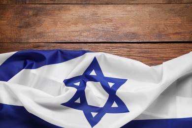 Photo of Flag of Israel on wooden background, top view and space for text. National symbol