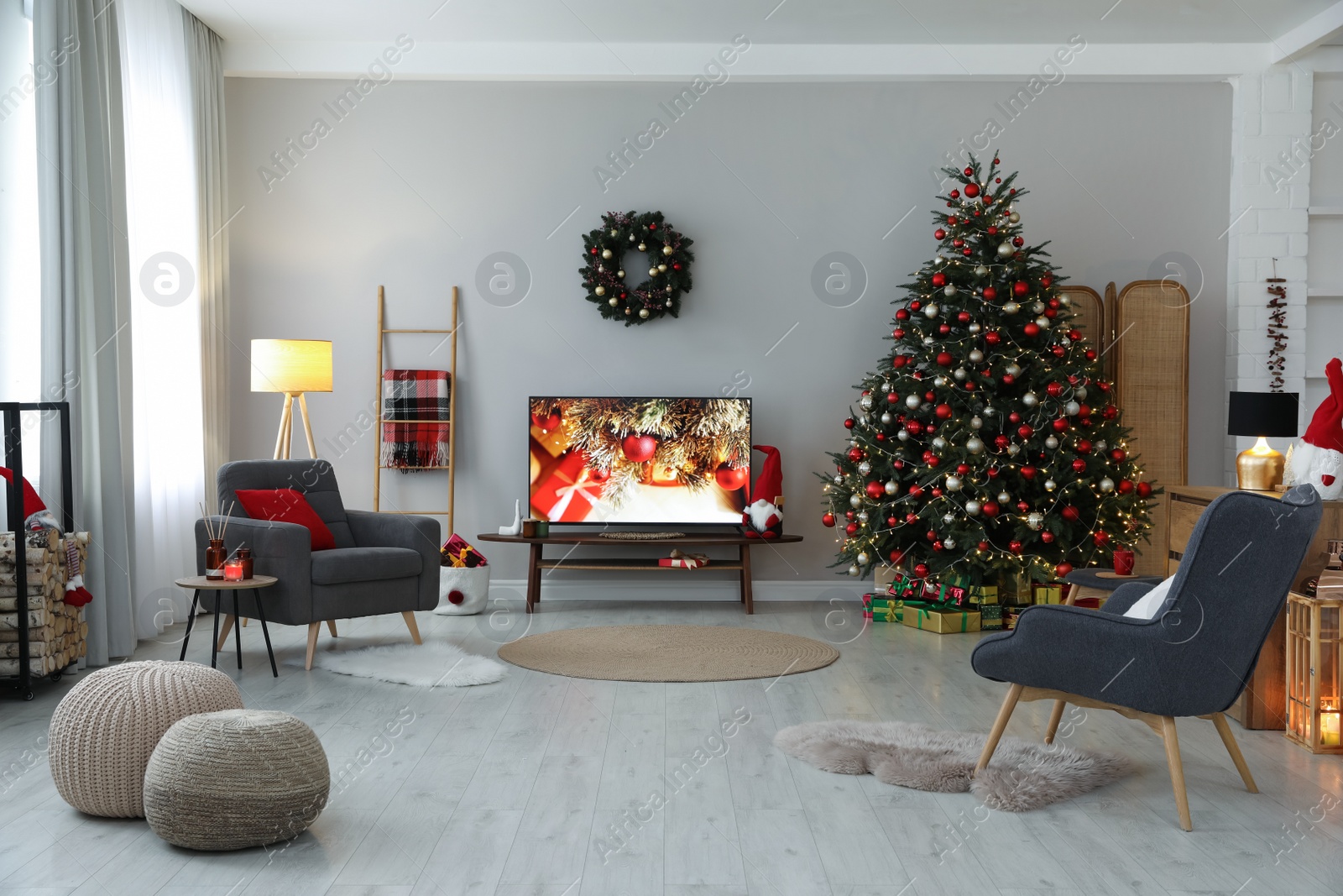 Photo of Stylish living room interior with modern TV and Christmas tree