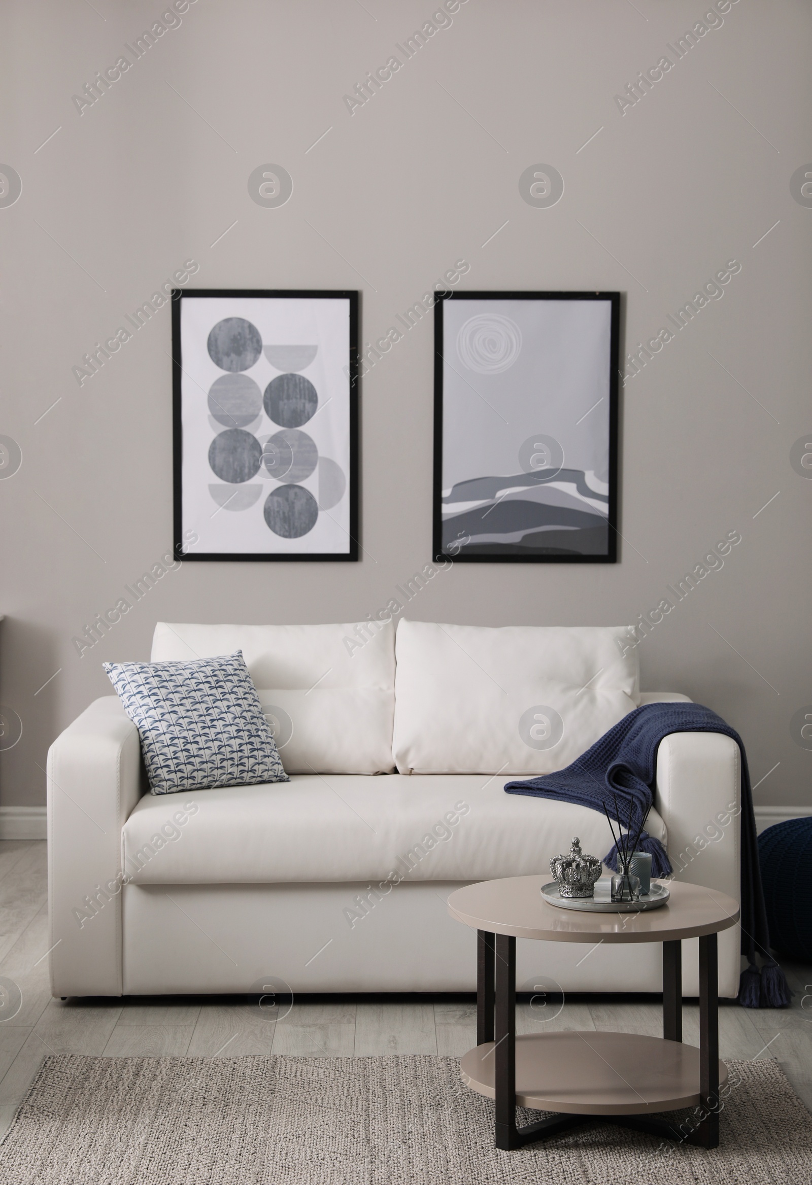 Photo of Stylish living room interior with white sofa and small coffee table