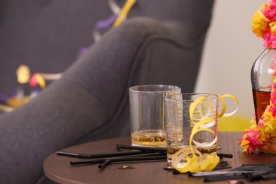 Photo of Messy table with glasses and straws after party indoors