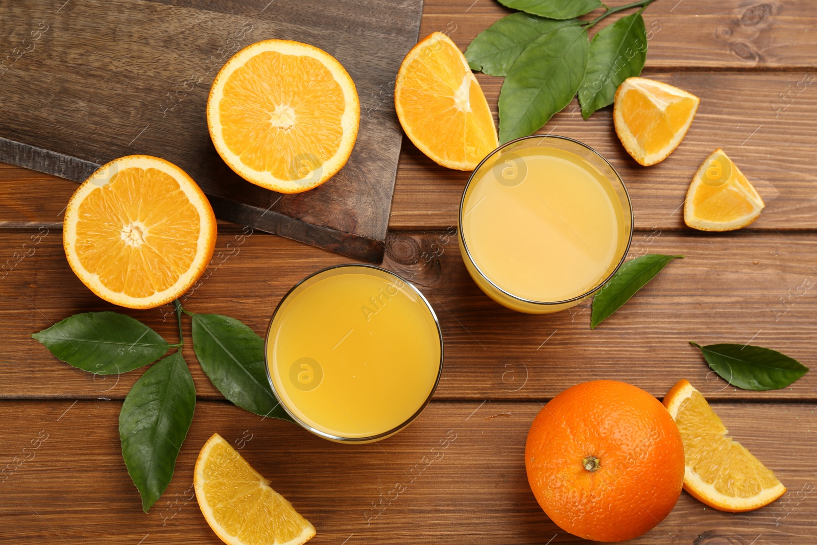 Photo of Delicious orange juice and fresh fruits on wooden table, flat lay