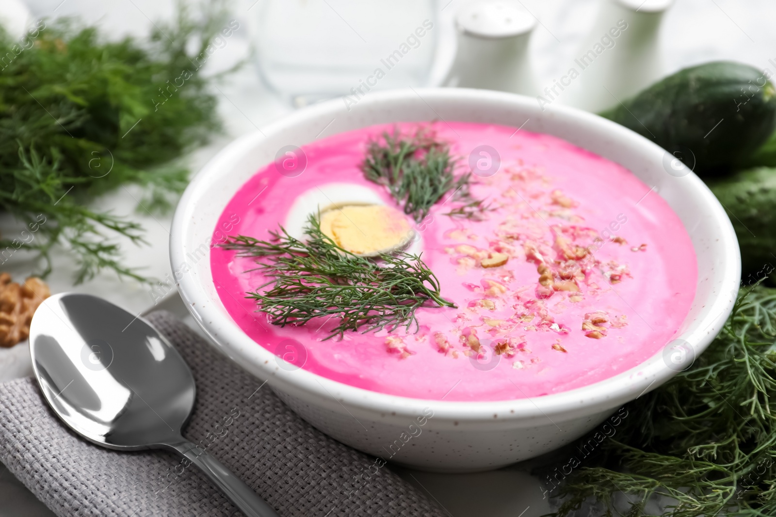 Photo of Delicious cold summer beet soup on table, closeup