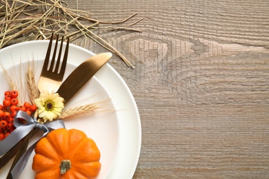 Photo of Festive table setting on wooden background, flat lay with space for text. Thanksgiving Day celebration