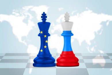 Image of Chess pieces in color of Russian and European Union flags against world map